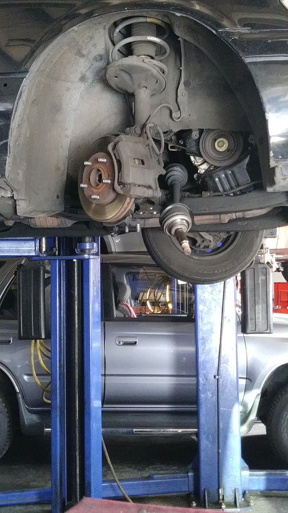 A wheel hub and brake assembly with the wheel removed, on the lift